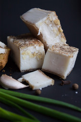 Bread with salted bacon and onions. Garlic on the table. Lunch, dinner. Meal.