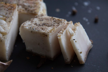 Bread with salted bacon and onions. Garlic on the table. Lunch, dinner. Meal.