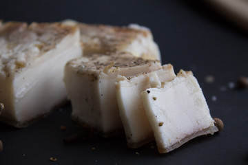 Bread with salted bacon and onions. Garlic on the table. Lunch, dinner. Meal.