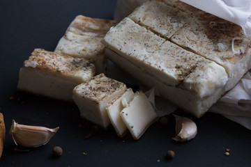 Bread with salted bacon and onions. Garlic on the table. Lunch, dinner. Meal.