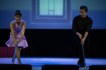 A pair of dancers a man and a woman perform in a theater on stage in a dance musical show.