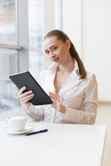 White blouse, tablet, smile