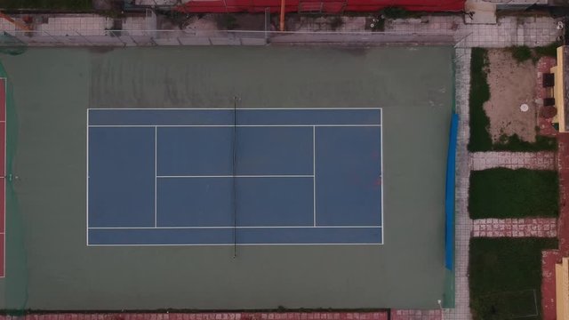 Rotating Aerial drone shot over tennis courts in a sports complex in Poseidonio, Thessaloniki Greece
