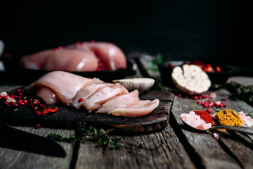 Raw Chicken Fillet on a Cutting Board