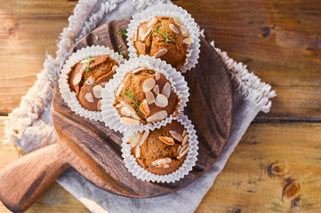 Delicious homemade coconut cinnamon muffins and caraway leafs on old white tray. Healthy food concept with copy space. Against the background of dry ears of wheat. in the style of rustic.