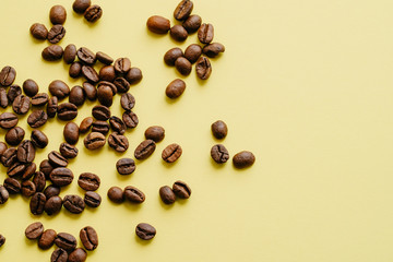 Cereal fresh aromatic Brazilian coffee. Brown grains on a yellow background. Free space for text.