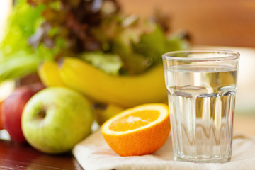Fresh organic vegetables and fruits with glass of water - health and diet concept