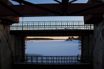 Dam along the road to the Voitsky Padun waterfall on the Lower Vyg River, Karelia, winter.