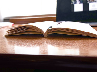 laptop and open notebook on wooden table. Concept remote study and work at home, telework, freelance, quarantine. Distance online learning, webinar, conference