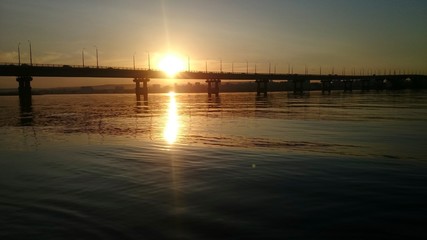 Sunset on the background of the bridge of Saratov