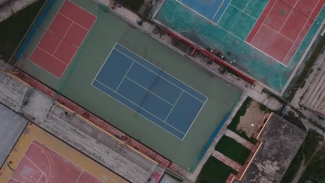 Rotating Aerial drone shot over tennis courts in a sports complex in Poseidonio, Thessaloniki Greece