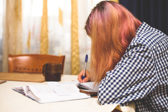 A girl performs a school task at home-distance learning during the coronavirus pandemic