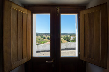 Fototapeta na wymiar View from a wooden door/window inside a house on the countryside