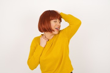 Shot of happy young woman with positive smile, has long hair, rejoices having weekend and good rest after hard working exhausting week, isolated on gray wall.