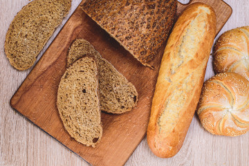 Сrisp bread with buns. French baguettes. Fresh crispbread. Bread background. Different breed  on wooden background.