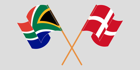 Crossed and waving flags of South Africa and Denmark