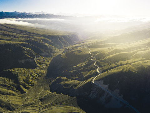Aerial view of serpentene to horizon into the mist of last hours of the sunset, Chechen republic, Russia