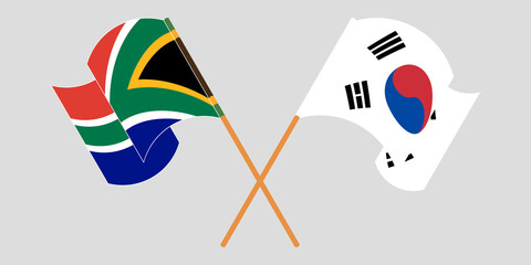 Crossed and waving flags of South Africa and South Korea