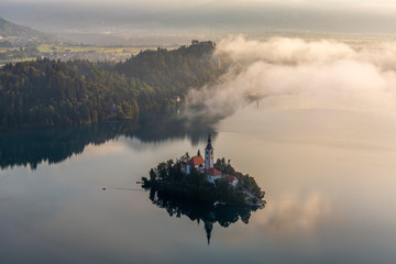 Aerial view of the Bled island and castle at sunrise