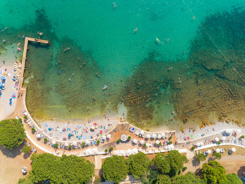 Aerial view of people enjoying the beach at Alba Chiara, Medulin, Croatia.