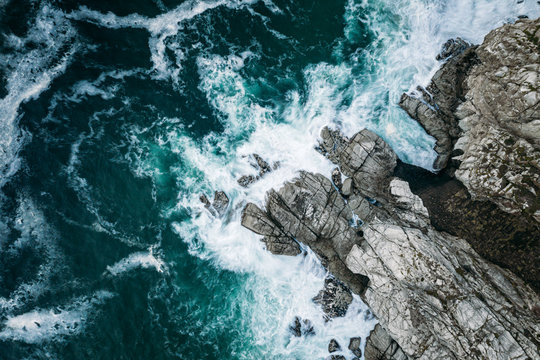 Aerial view of ocean breaking on rocks at Chapmans Peak Drive, Cape Town, South Africa.