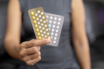 Woman holding combined oral contraceptive pill.Gynecology concept.