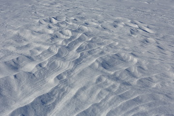 Snow crust. Snowy texture. Gray background.
