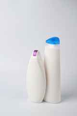 Colorful towels and shampoo and bath foam on a white background