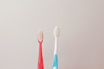  Red and blue toothbrushes on a gray background. Old and new toothbrush. Oral hygiene concept. copy space for text