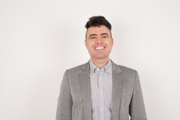 Horizontal portrait of pleasant-looking Caucasian male wearing casual clothes looking happily to the camera.