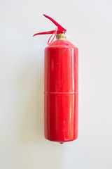 Fototapeta premium fire extinguisher on a white wall background. fire concept