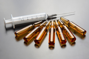 medical ampoules for injection and syringe. medicines and disease treatment. pharmacology and science