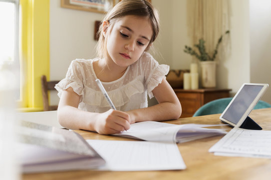 Girl (6-7)&dagger;working on schoolwork at home