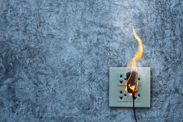 On fire charger adapter on the concrete wall exposed concrete background with space