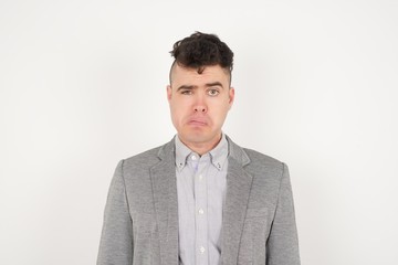 Handsome young man being nervous and scared biting lips looking camera with impatient expression, pensiveï¿½