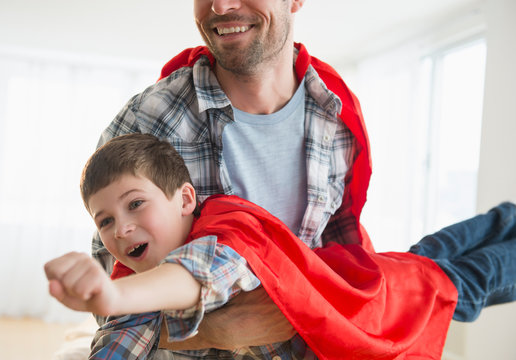 Father and son (8-9) acting as super heroes