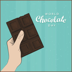 World Chocolate Day greeting card or poster in vintage style. Hand holding black chocolate, vecror illustration in engraving style