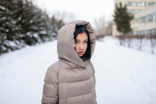 Young woman in hooded jacket during winter