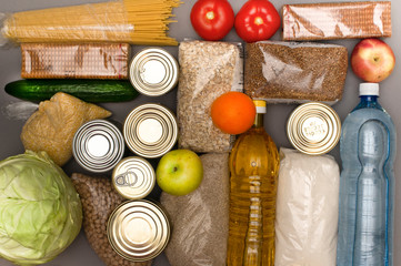 A set of basic products - cereals, sugar, sunflower oil, bottled water, canned food, peas, cookies,...