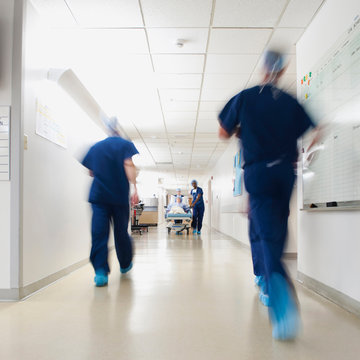 Medical team walking along hospital corridor before operation