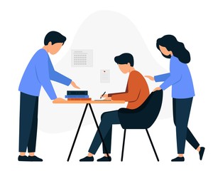 Parents with their child do their homework. A boy sits at a table and writes.