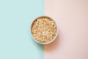 oatmeal in a bowl on a pastel background, copy space