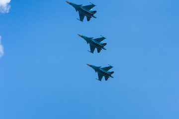 A group of professional pilots of military aircraft in sky. 