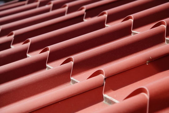 Roof. Red brown metal roof of the house.