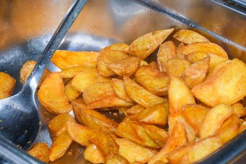 Baked potato wedges with cheese.