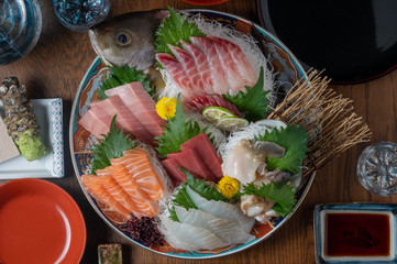 authentic japanese sashimi platter with sake - obrazy, fototapety, plakaty