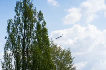 A group of professional pilots of military aircraft in sky. 