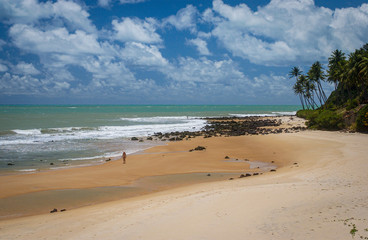 Fototapeta na wymiar Chalk beach, Tibau do Sul, near Natal, Rio Grande do Norte, Brazil on October 15, 2013. Woman walking on the beach