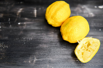 Squeezed lemon on a dark background.