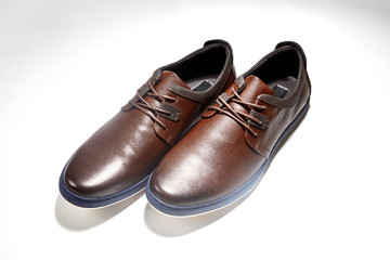 Men fashion brown shoe leather over white background. Pair casual stylish footwear.